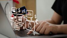 woman holding credit card using computer to shop online at home