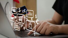 woman holding credit card using computer to shop online at home